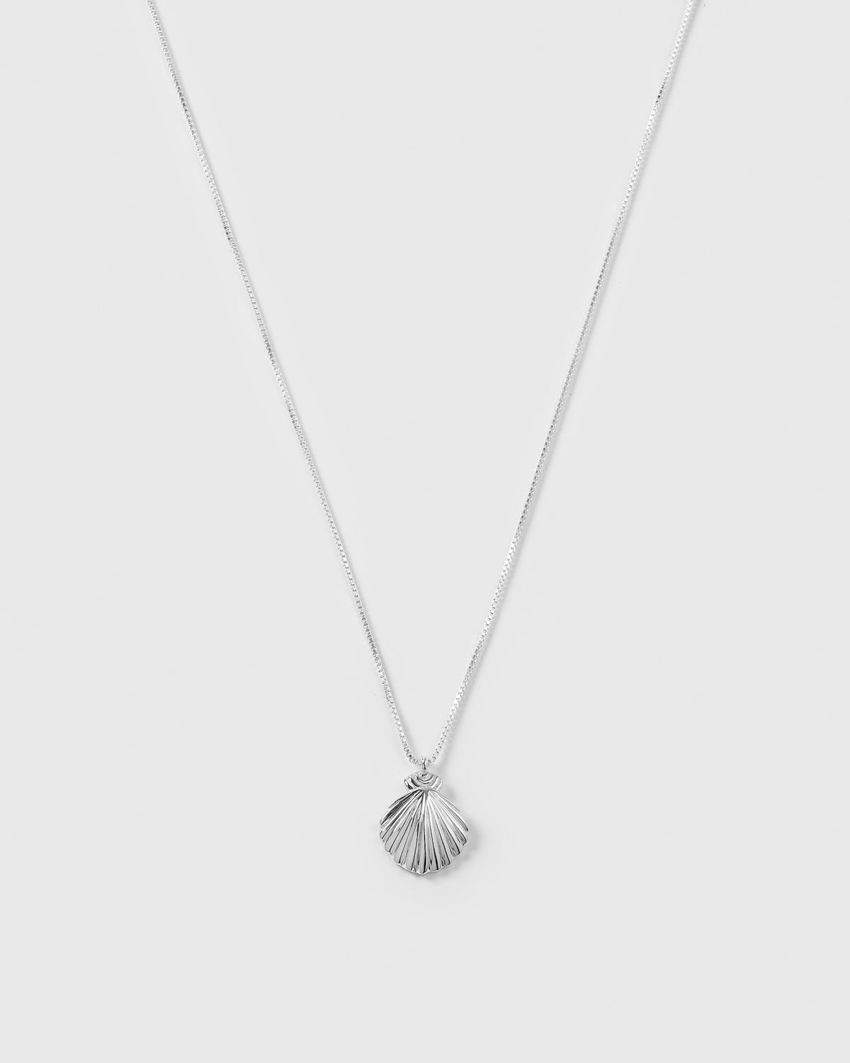 A product shot of the Beaches Shell Necklace in silver, featuring its fine chain and detailed shell-shaped pendant.