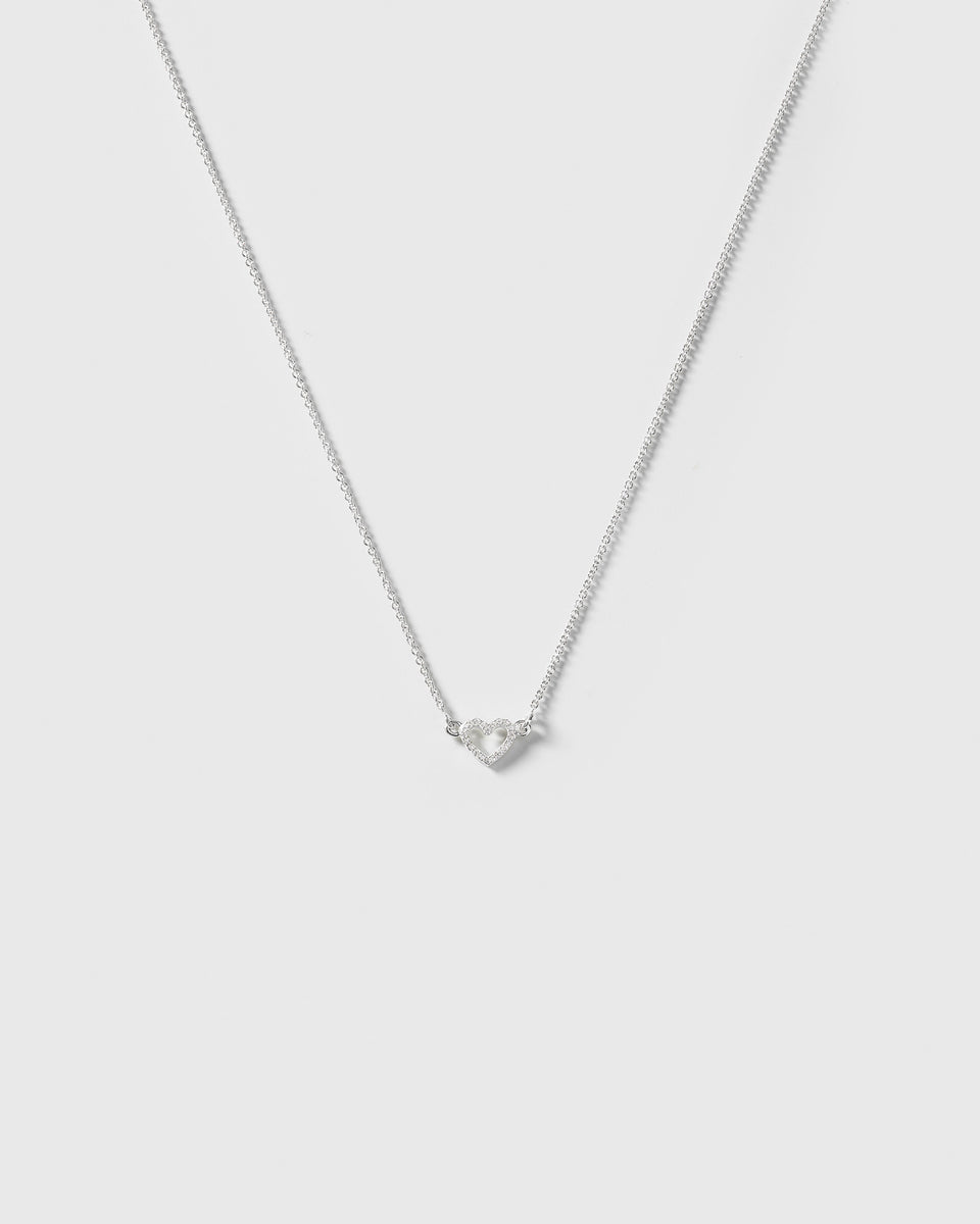 A product shot of the Snap Heart Necklace in silver, featuring a fine chain and a heart-shaped pendant covered in sparkling crystals.