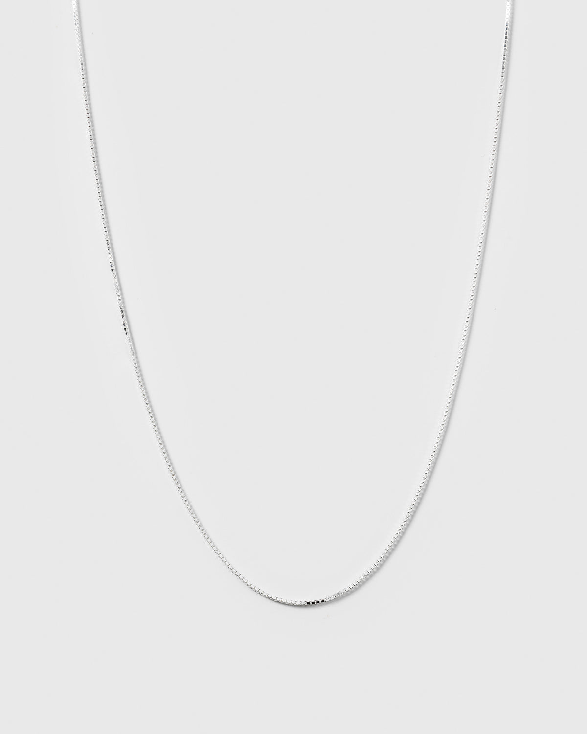 A product shot of the Beloved Long Box Chain in silver, highlighting its delicate and classic box chain design.