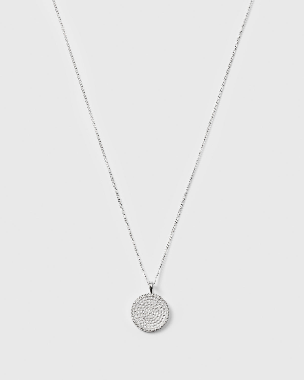 A product shot of the Lucky Coin Heal Necklace in silver, showing its fine chain and the front of the circular pendant which features a detailed sun pattern.