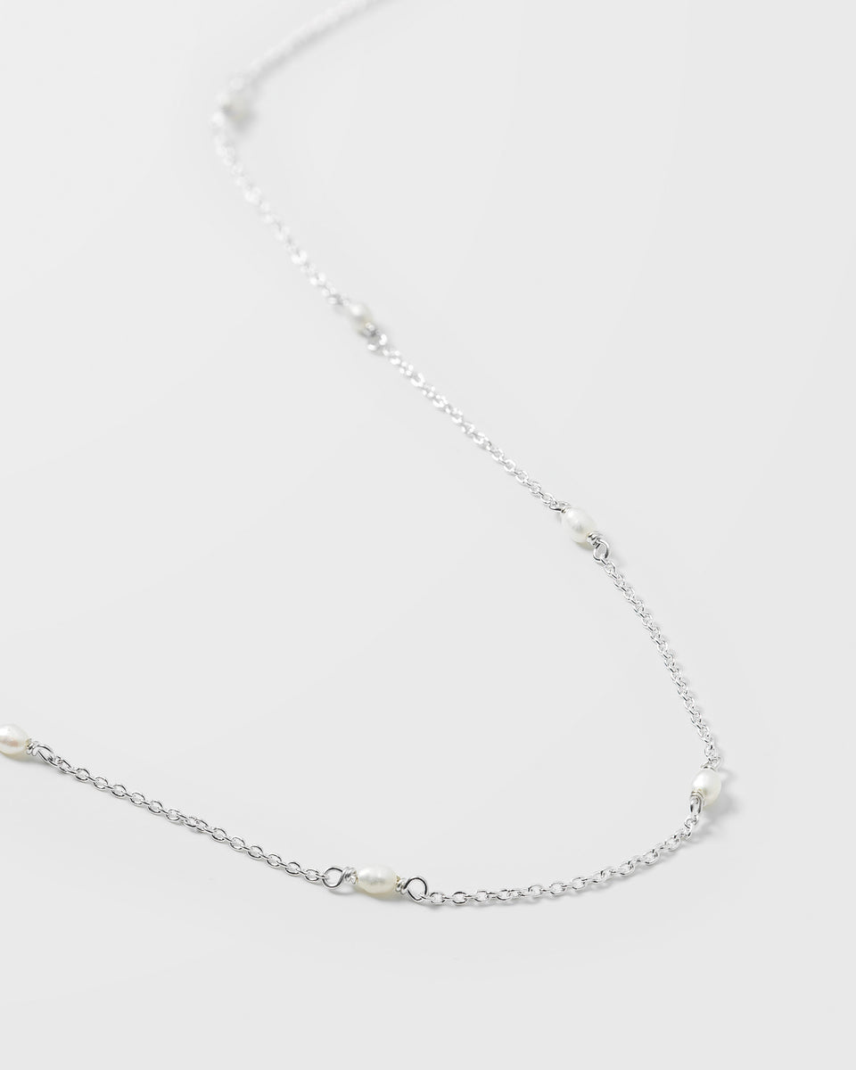 A close-up image of the Treasure Multi Pearl Necklace in silver, detailing its delicate chain and the small freshwater pearls spaced along it.