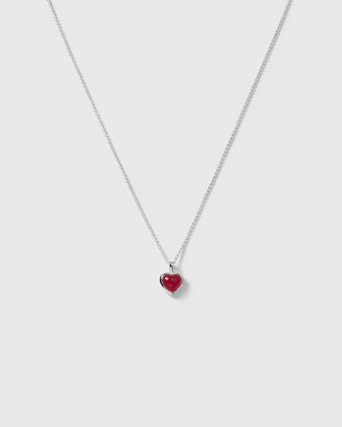 The La La Love Necklace in silver, featuring a heart-shaped pink quartz pendant on a delicate sterling silver chain.