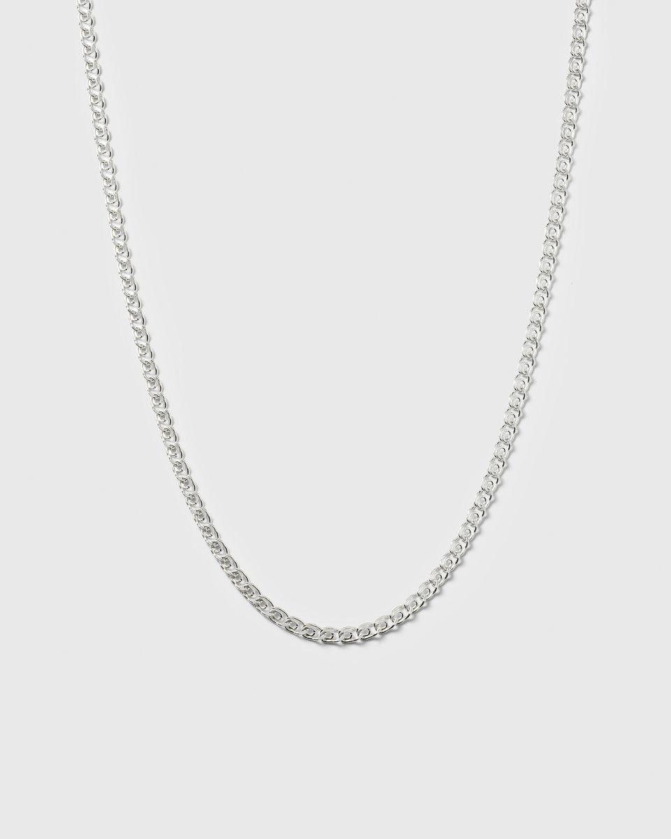 A product shot of the Sheer Love Necklace in silver, displayed in a U-shape to highlight its uniquely patterned links.