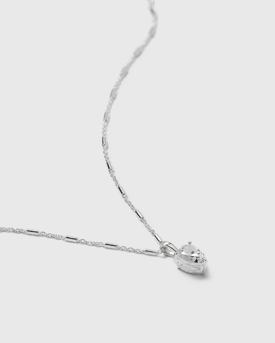 A product shot of the Katie Necklace in silver, featuring its unique chain and a drop-shaped pendant set with a sparkling cubic zirconia.