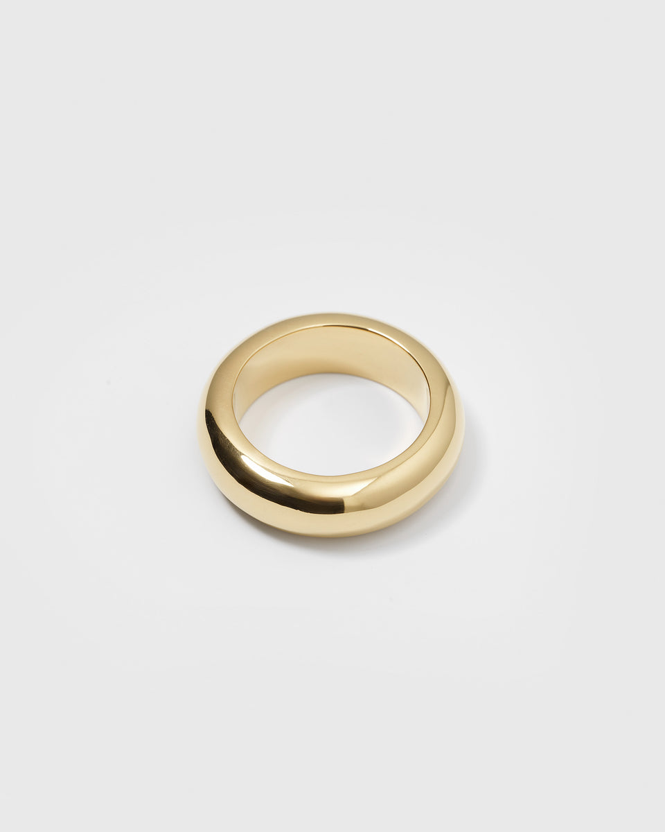 A product shot of the Bolded Ring Gold, a chunky statement ring with a smooth, polished, and rounded design.