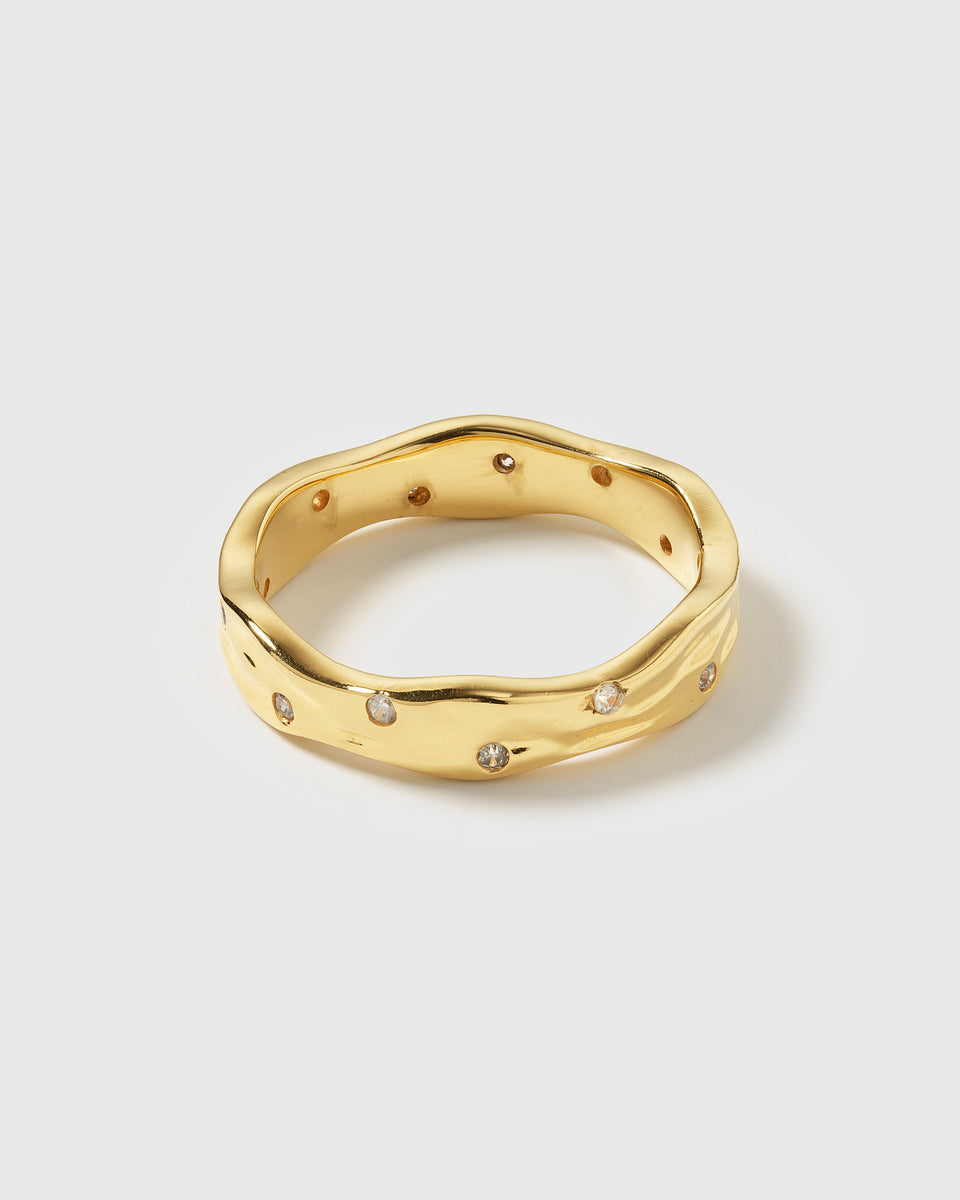 A product shot of the Melting Narrow Ring in gold, showcasing its unique melted design and irregularly set sparkling zirconias.