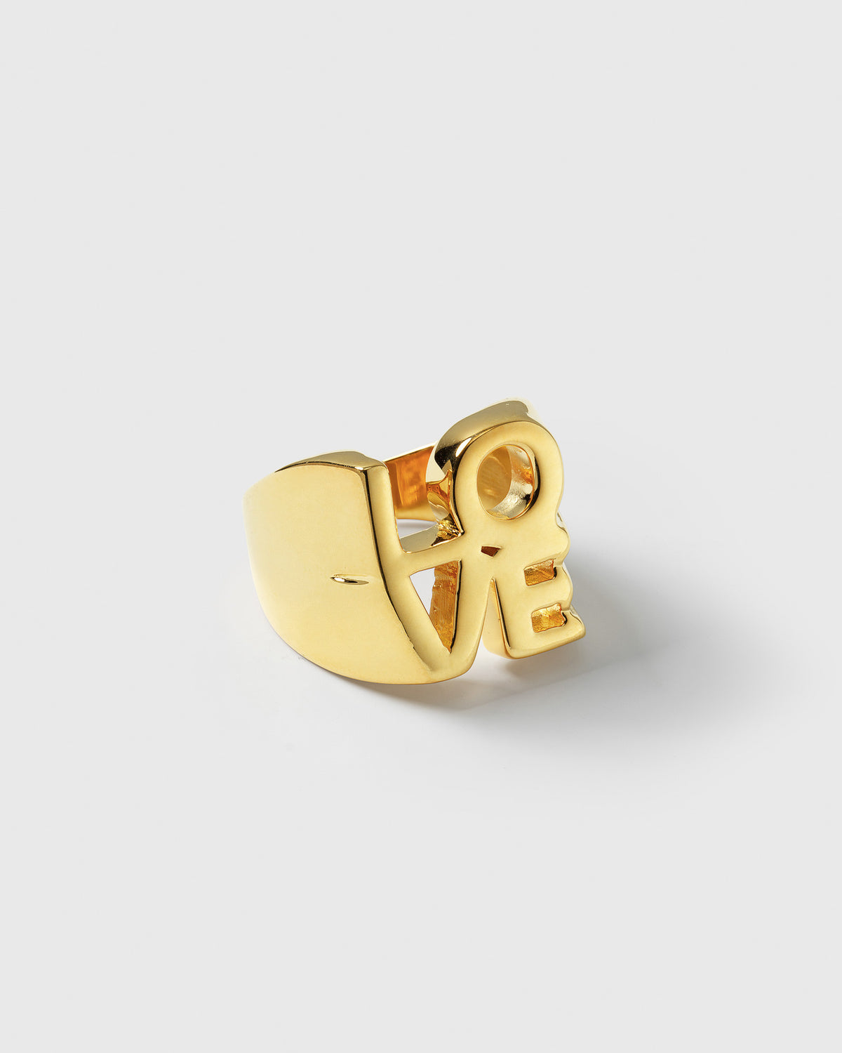 A product shot of the True Love Ring in gold, showing its chunky statement design that spells out the word 'LOVE'.