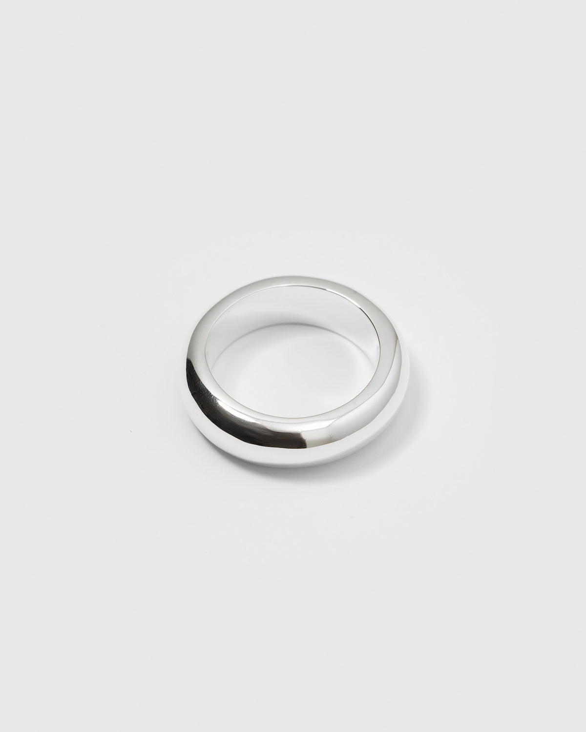 A product shot of the Bolded Ring in silver, highlighting its chunky, rounded band design with a polished finish.