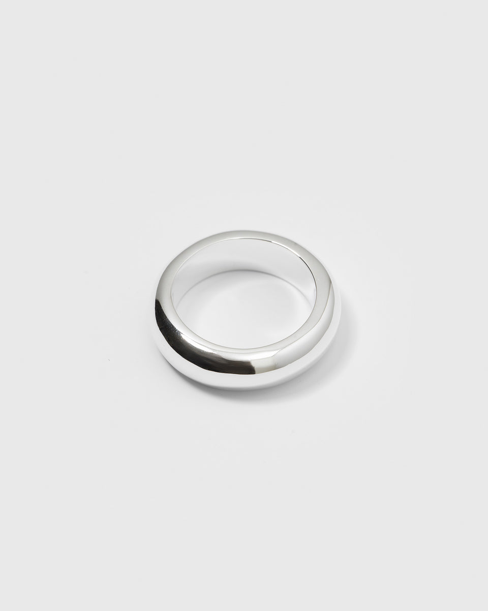 A product shot of the Bolded Ring in silver, highlighting its chunky, rounded band design with a polished finish.