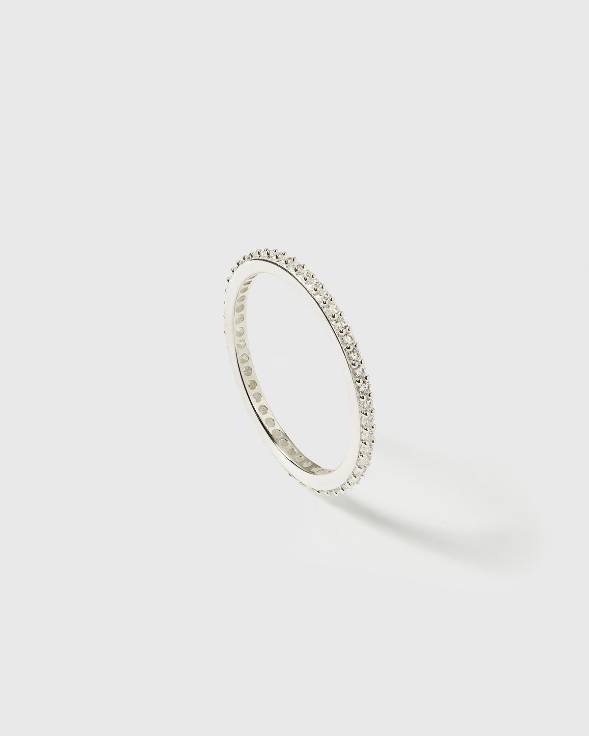 A product shot of the Tiny Sparkle Ring in silver, featuring its eternity band design set with small sparkling zirconias.
