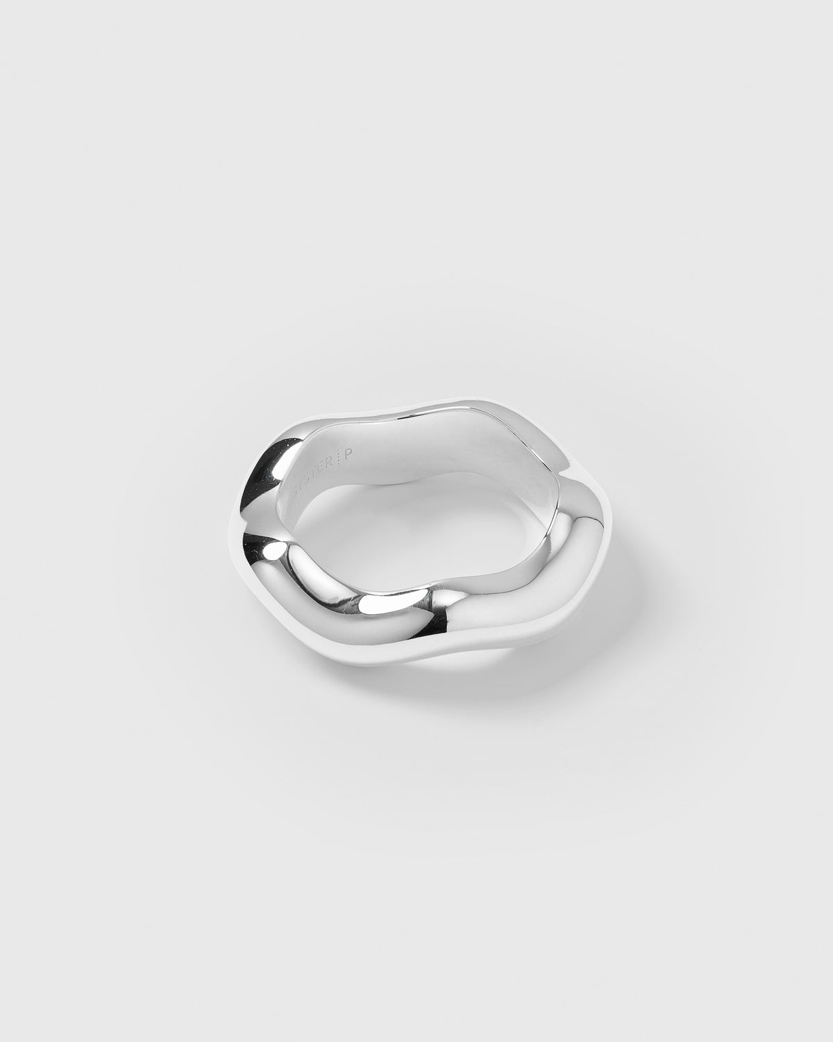 A product shot of the Bolded Wavy Ring in silver, highlighting its thick and shiny band with a distinct, softly rounded wavy design.