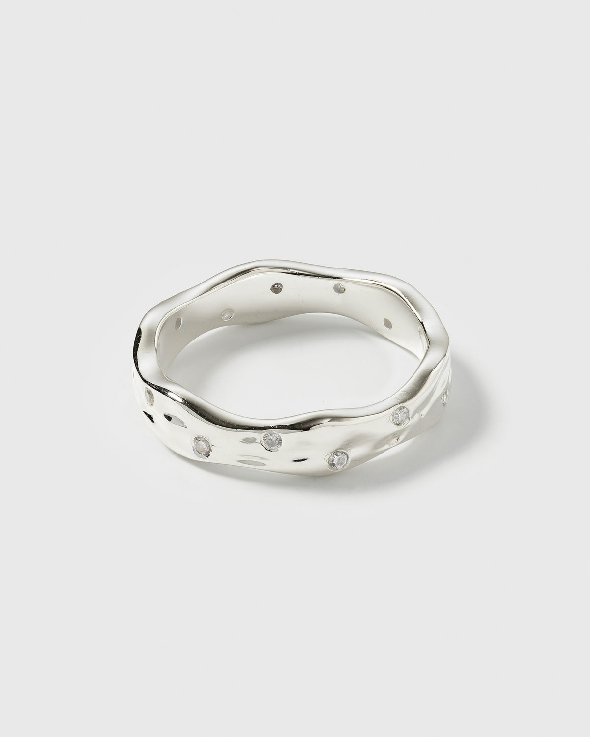 A product shot of the Melting Narrow Ring in silver, featuring its unique wavy, melted design and set with sparkling zirconias.