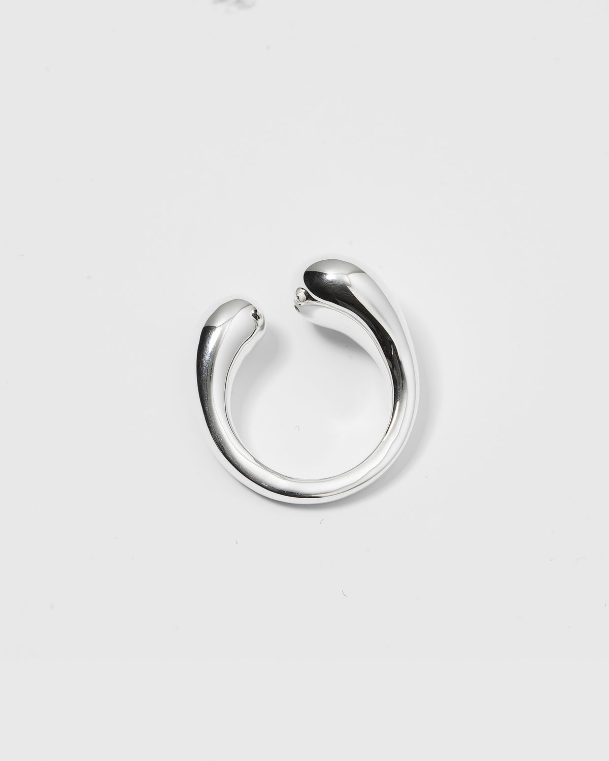 A product shot of the Bolded Drops Ring in silver, showcasing its open design with two bold, drop-shaped ends.
