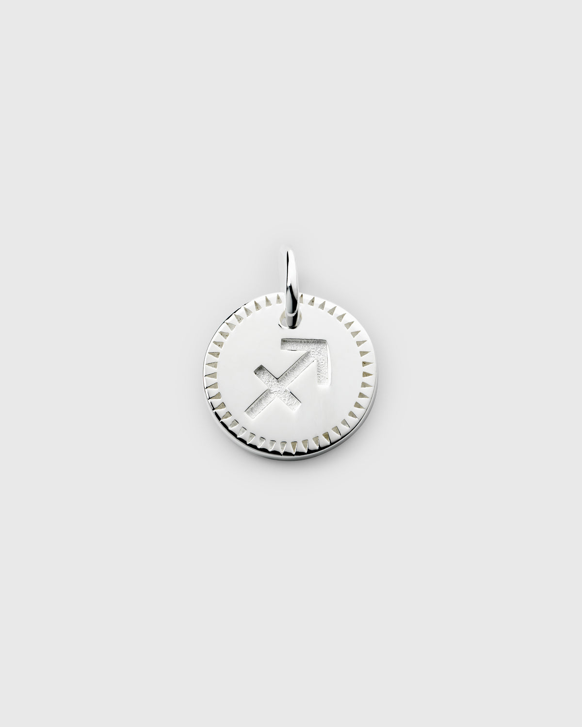 A product shot of the Beloved Zodie Pendant in silver, featuring the engraved Sagittarius zodiac symbol on a round charm with a decorative border.