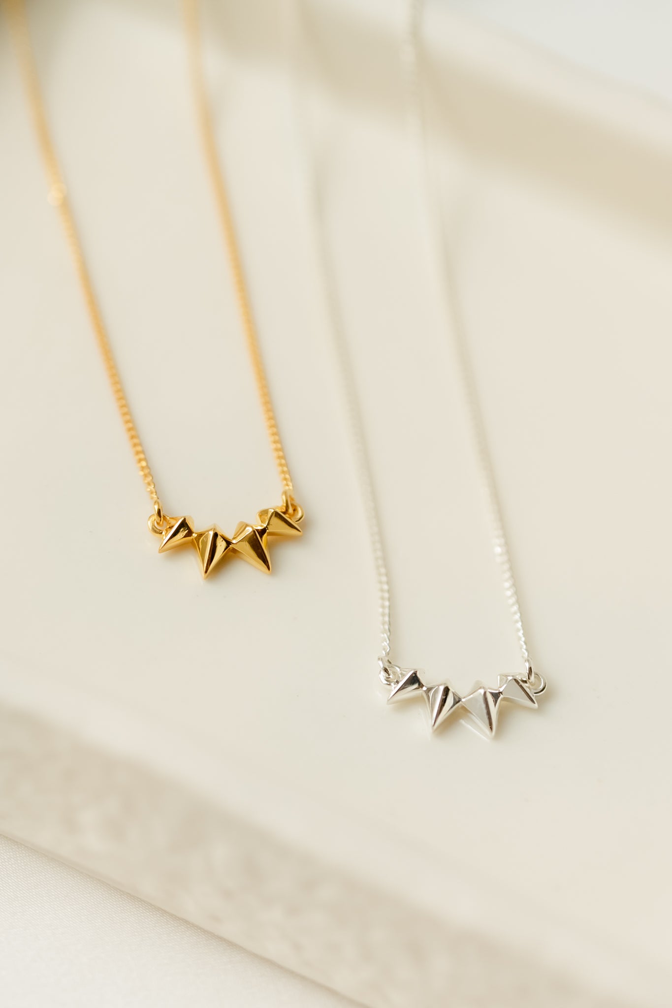 Gold necklace with small spikes and silver necklace with small spikes