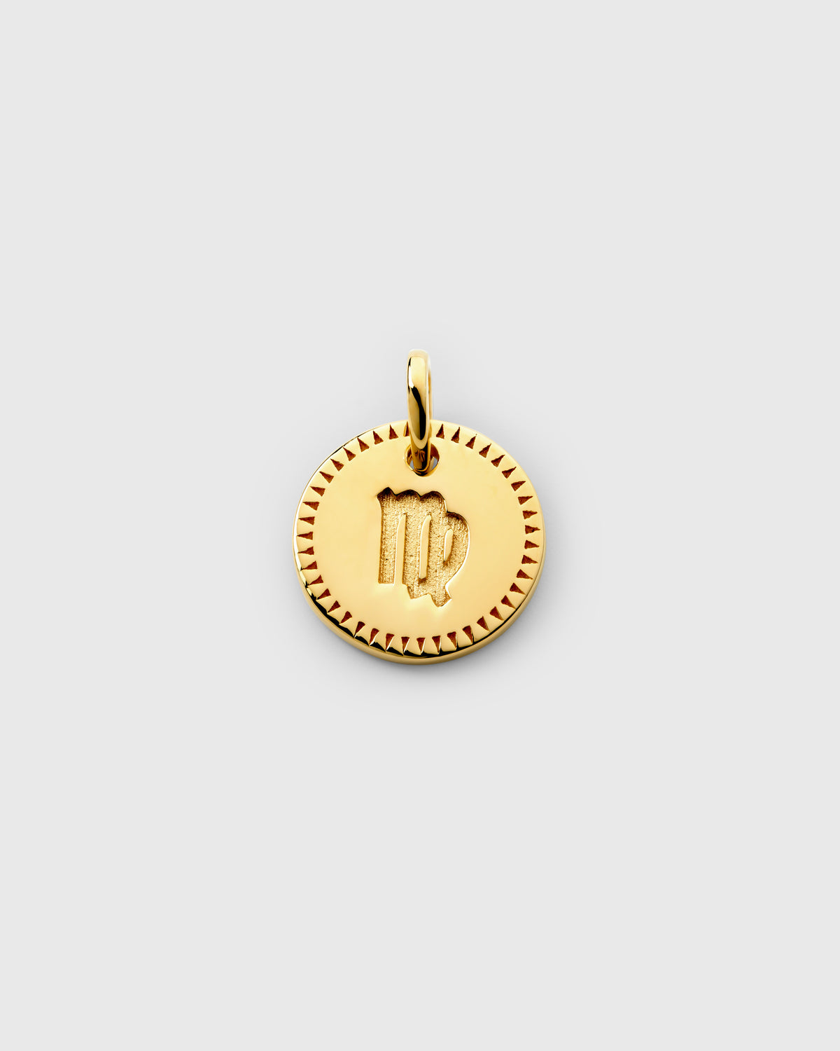 A product shot of the Beloved Zodie Pendant in gold, featuring the Virgo variant with its engraved zodiac symbol in the center, framed by a decorative border.