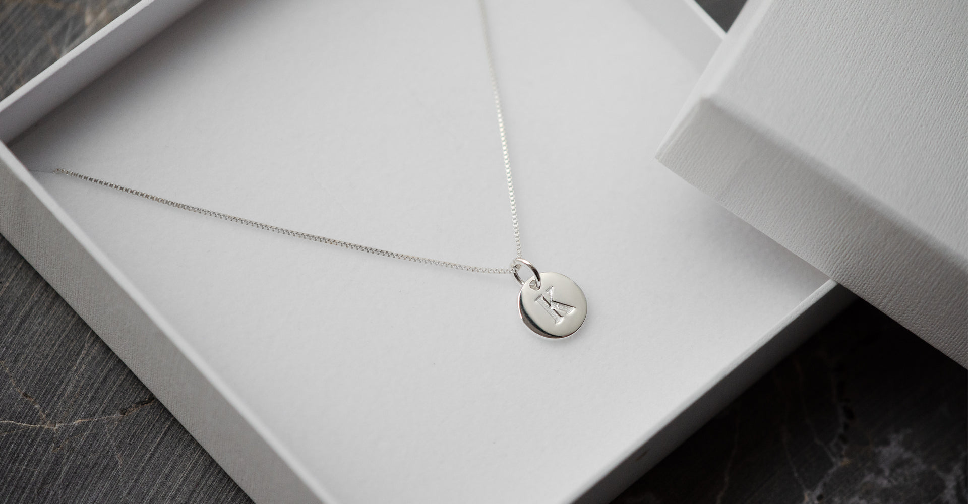 Silver necklace with a silver mini letter charm