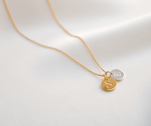 Letter pendant necklace with a combination of gold and silver