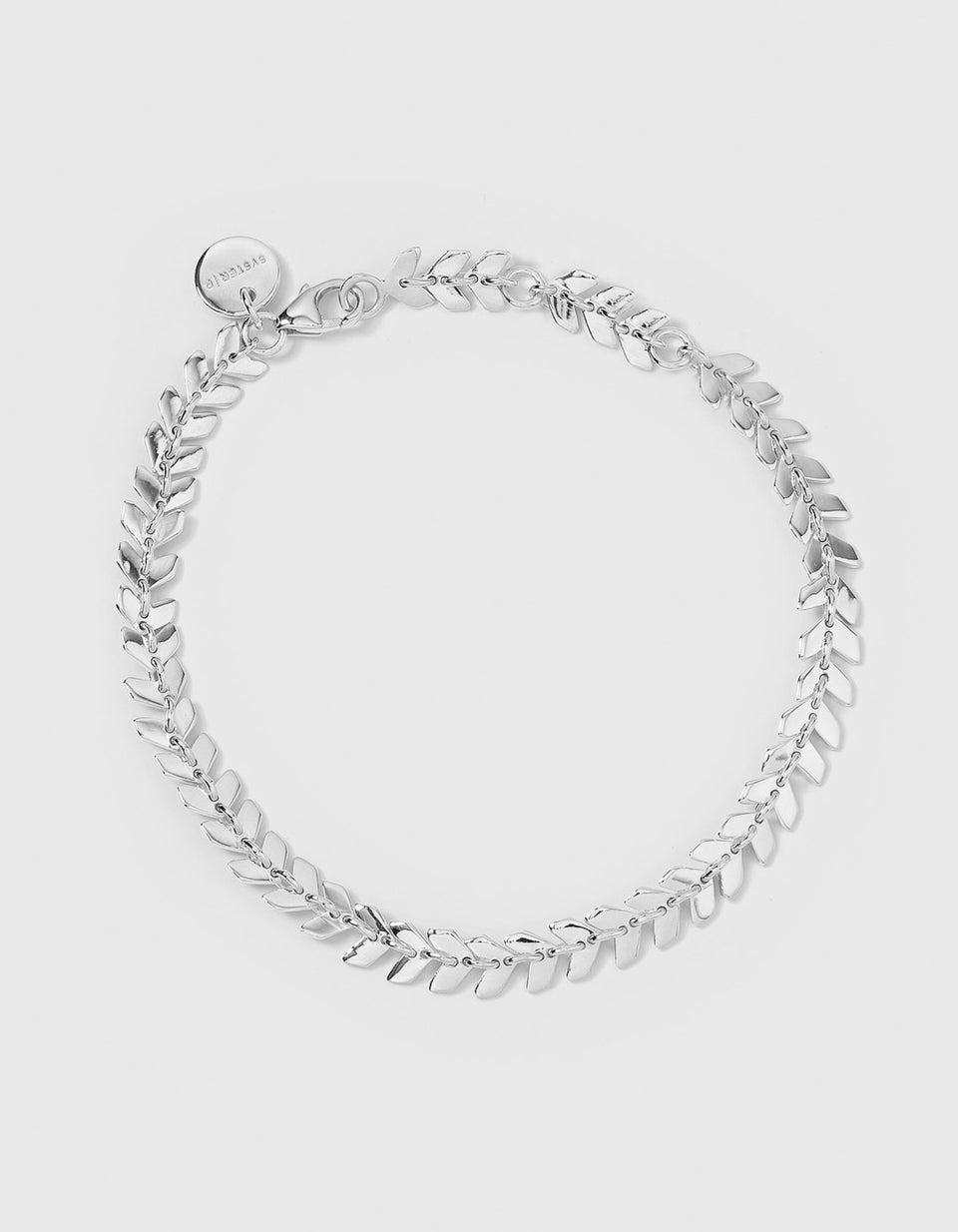 Studio shot of the Layers Olivia Bracelet in silver, laid out in a circle. The bracelet features a delicate pattern of small, interconnected leaf-like links.