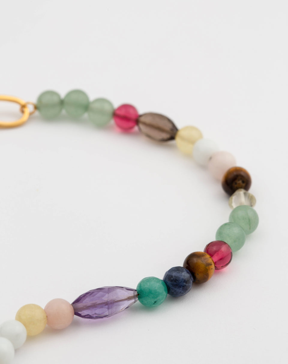 A close-up image of the Dream Catcher Bracelet Gold, detailing its eclectic mix of colorful natural stones and beads in various shapes and sizes.