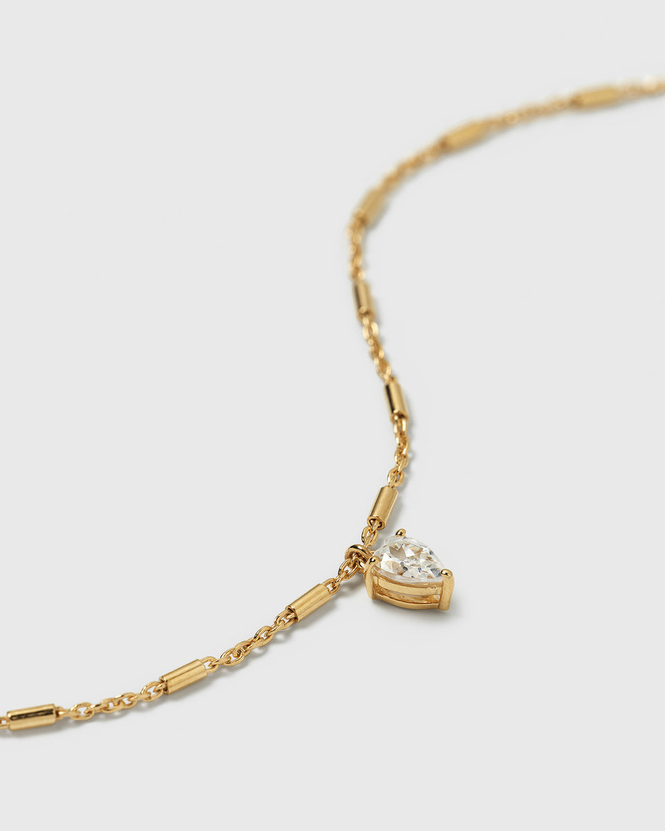 A close-up product shot of the Katie Bracelet in gold, highlighting its delicate chain with small bar details and its drop-shaped cubic zirconia charm.