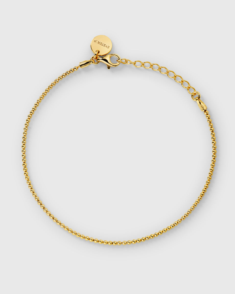 A sleek, minimalist bracelet with a delicate beaded chain that offers a soft shimmer and refined elegance for everyday wear.
