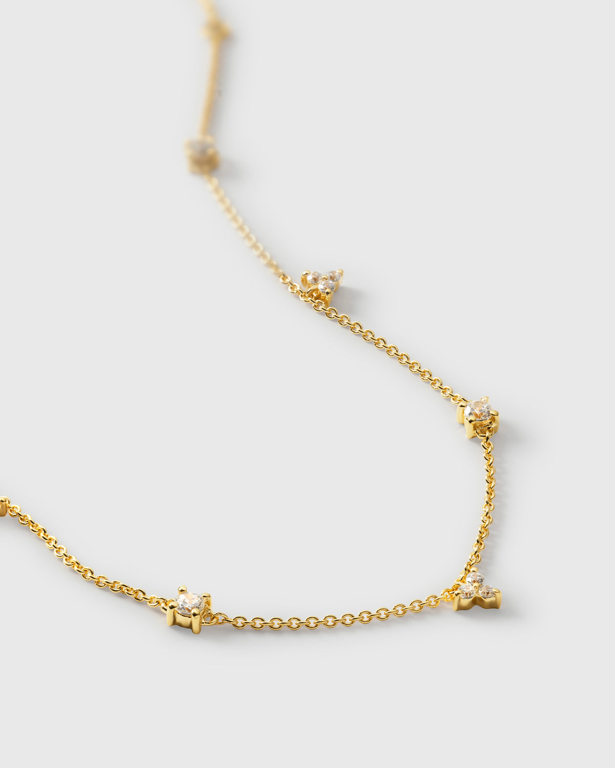 A close-up shot of the Celestia Bracelet in gold, showing its delicate chain design adorned with sparkling cubic zirconia stones.
