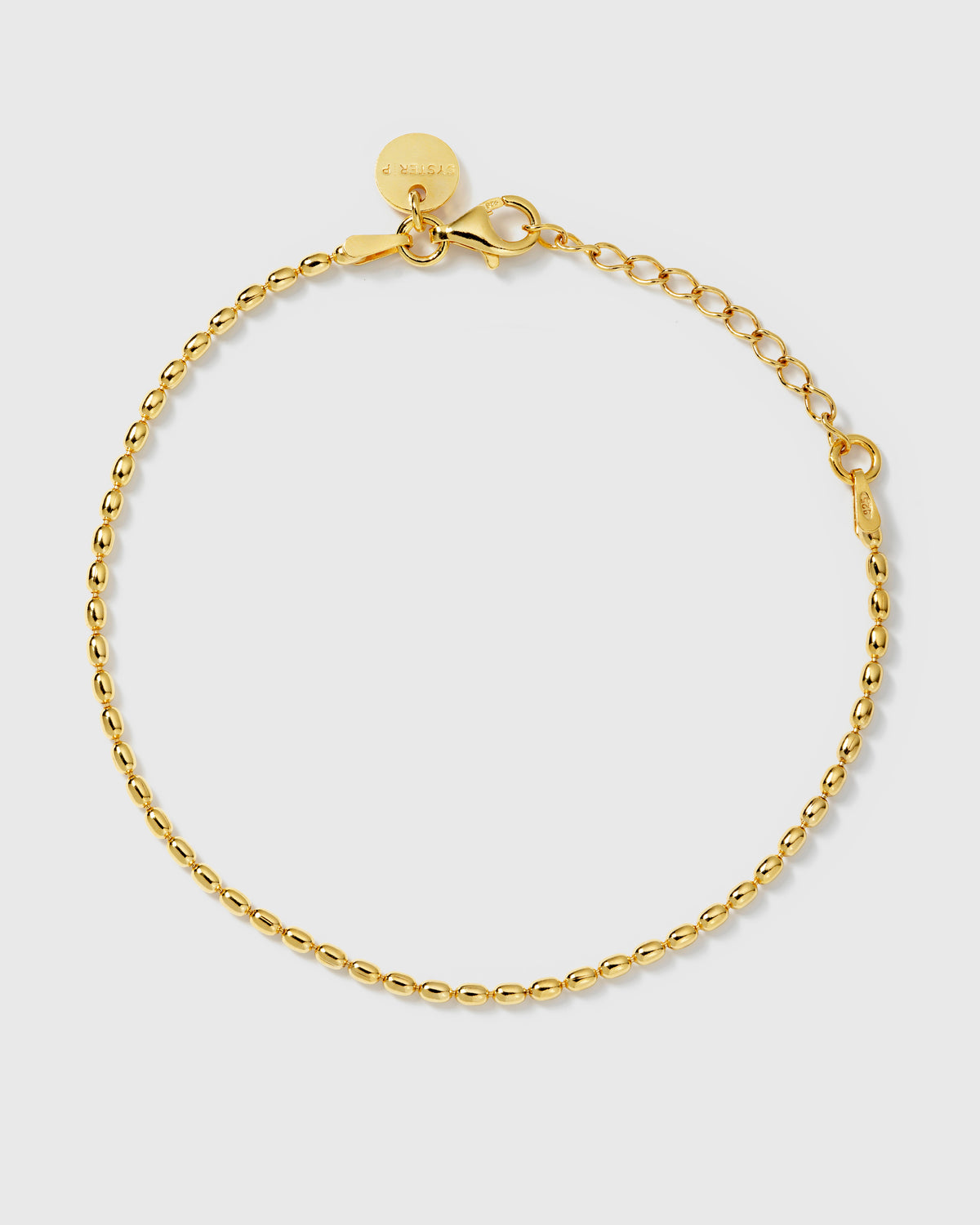 A product shot of the Lunetta Bracelet in gold, laid out in a circle to show its delicate design of small, oval-shaped beads.
