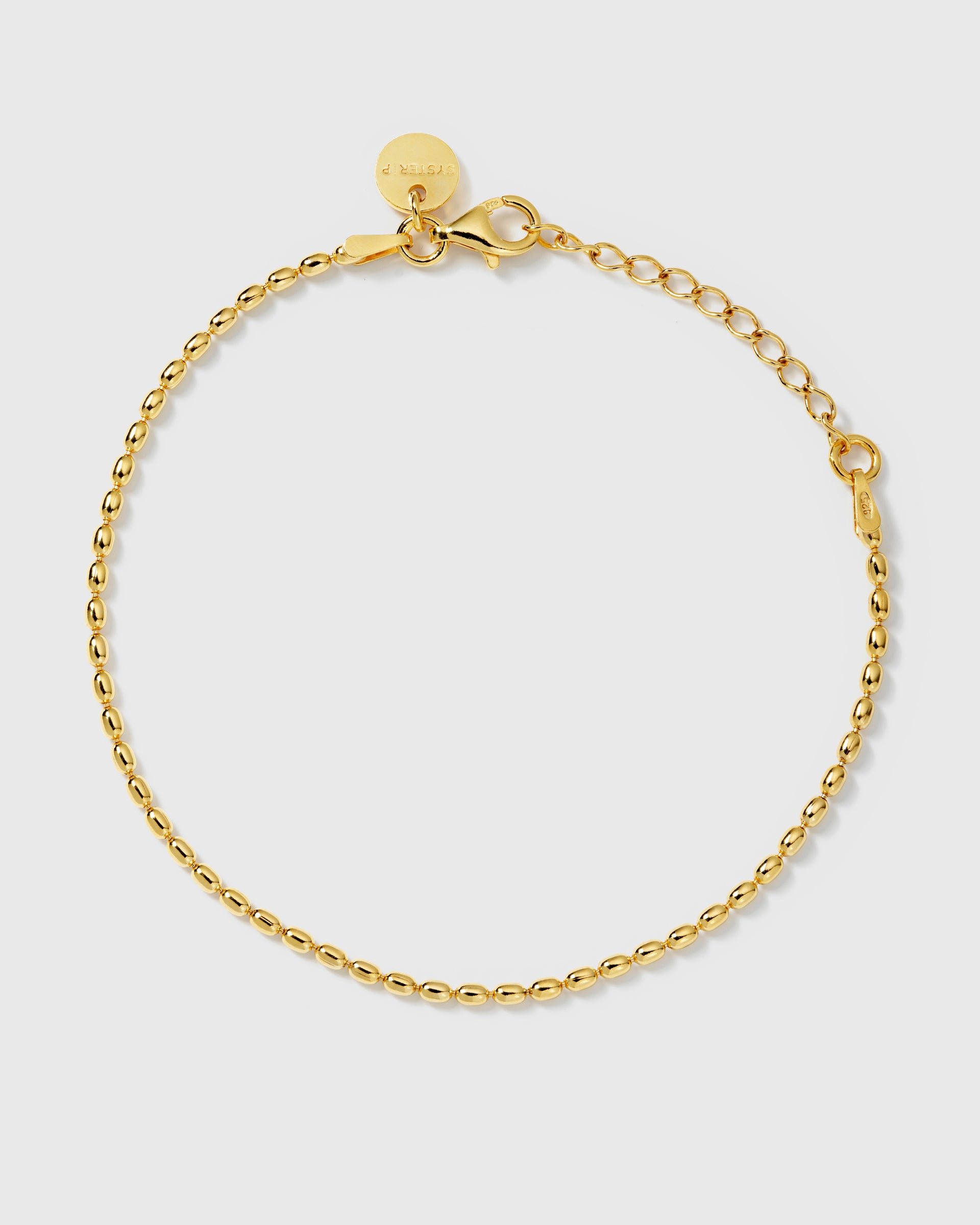 A product shot of the Lunetta Bracelet in gold, laid out in a circle to show its delicate design of small, oval-shaped beads.