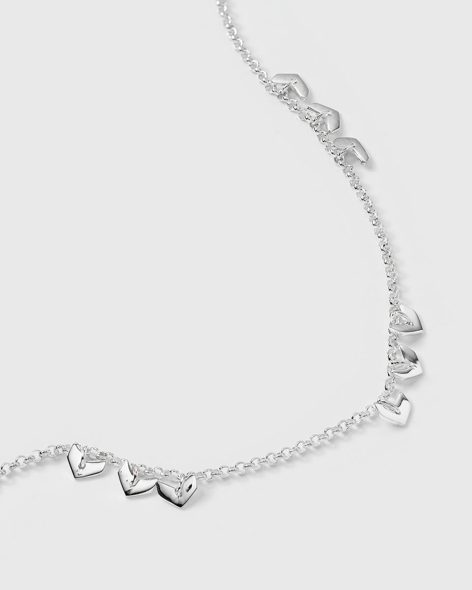A close-up image of the Layers Bianca Bracelet in silver, detailing its pattern of small, grouped leaf-like charms on a delicate chain.