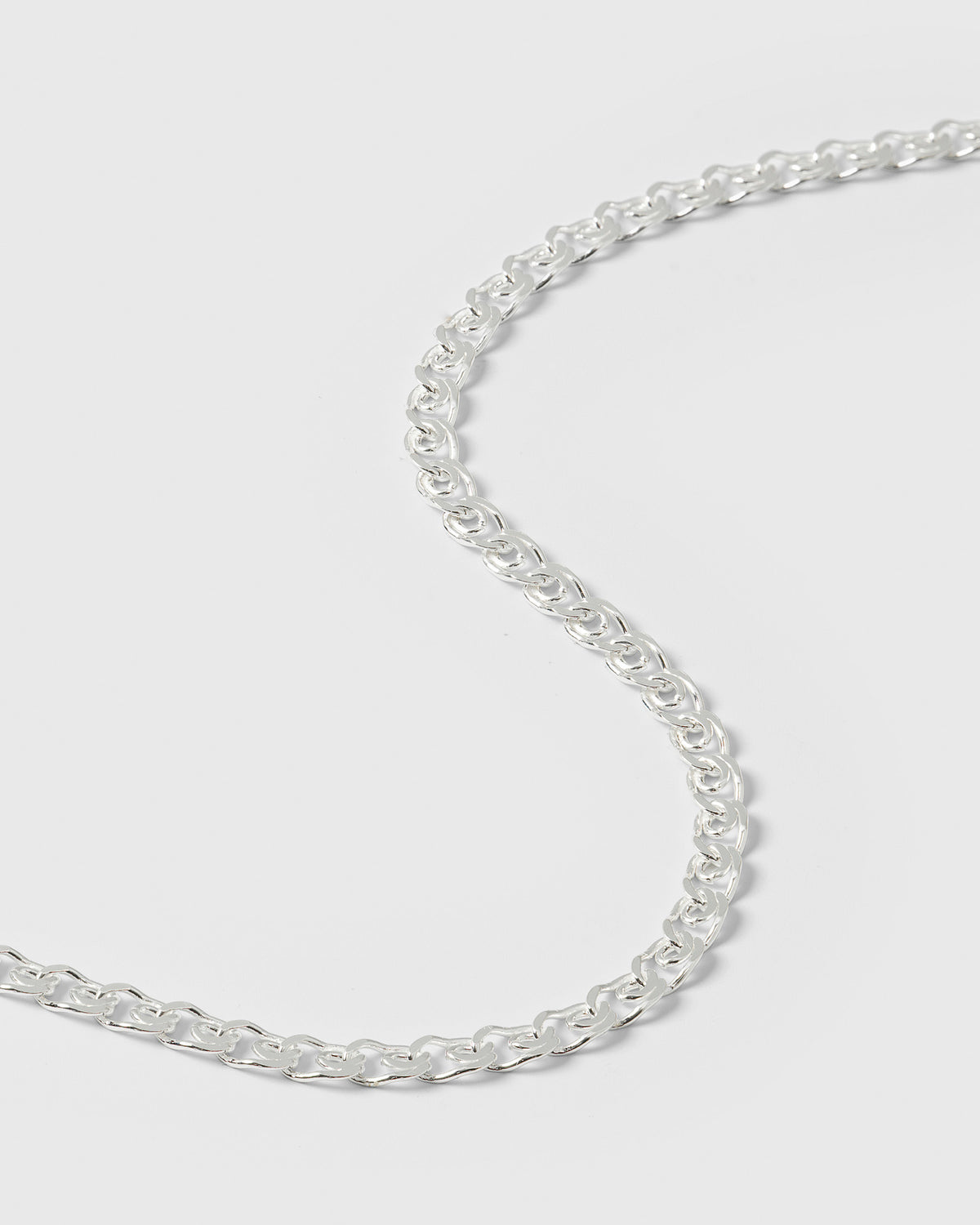 A close-up shot of the Sheer Love Bracelet in silver, showcasing the unique pattern of its chain links.