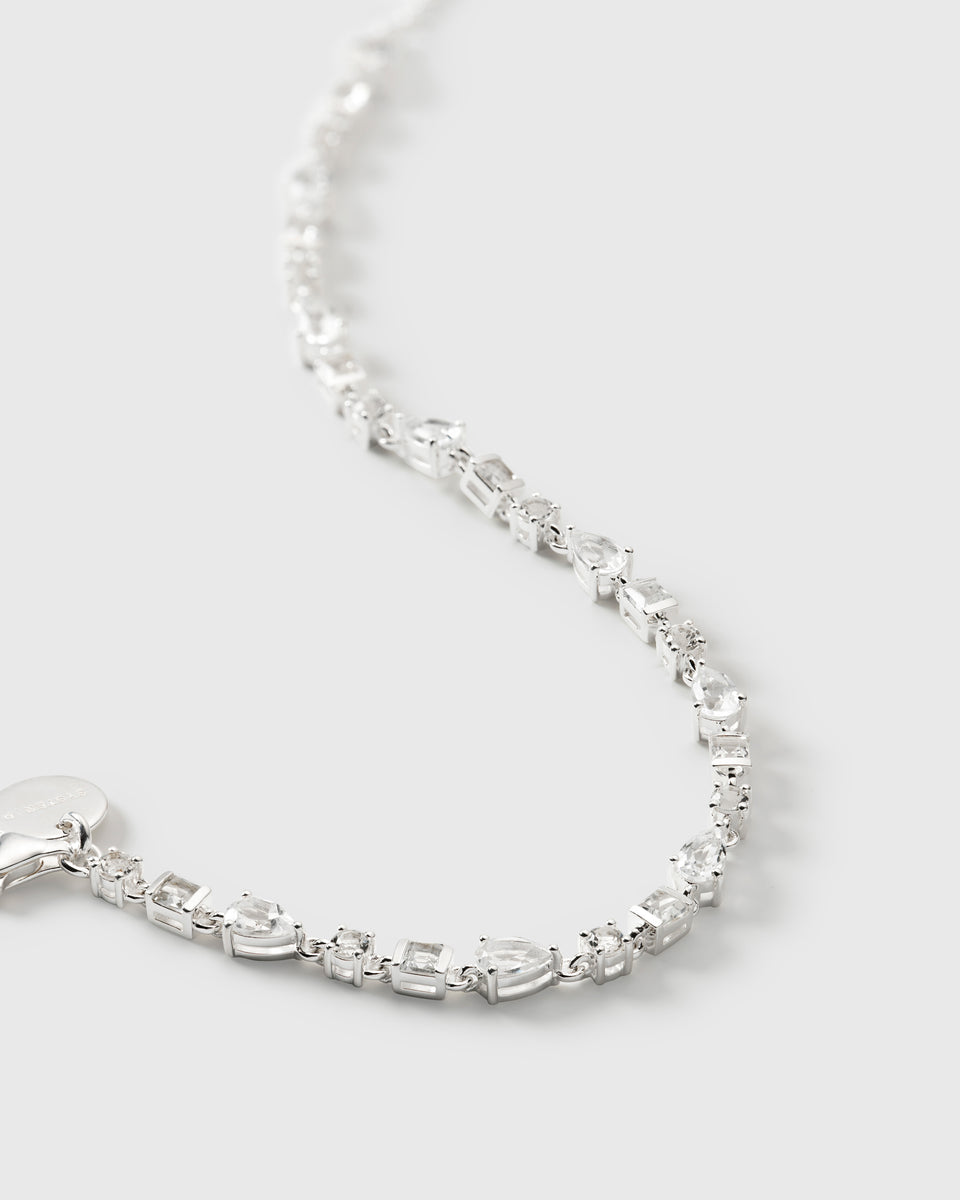 A close-up product shot of the Pam Bracelet in silver, highlighting its intricate design featuring various shapes of sparkling white topaz stones.