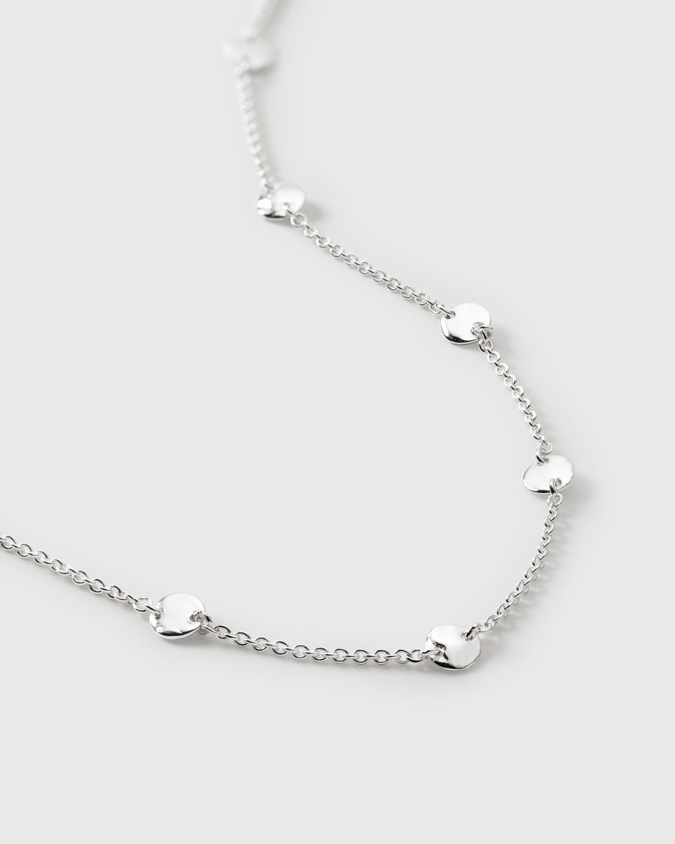 A close-up image of the Solea Bracelet in silver, showing the detail of its delicate chain and small, round, hammered circles.