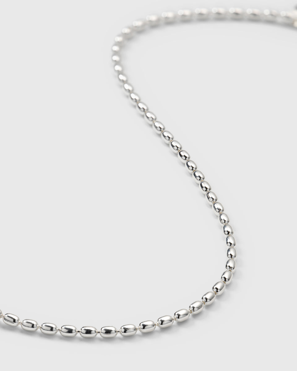A close-up product shot of the Lunetta Bracelet in silver, highlighting the details of its ball chain design composed of polished oval beads.