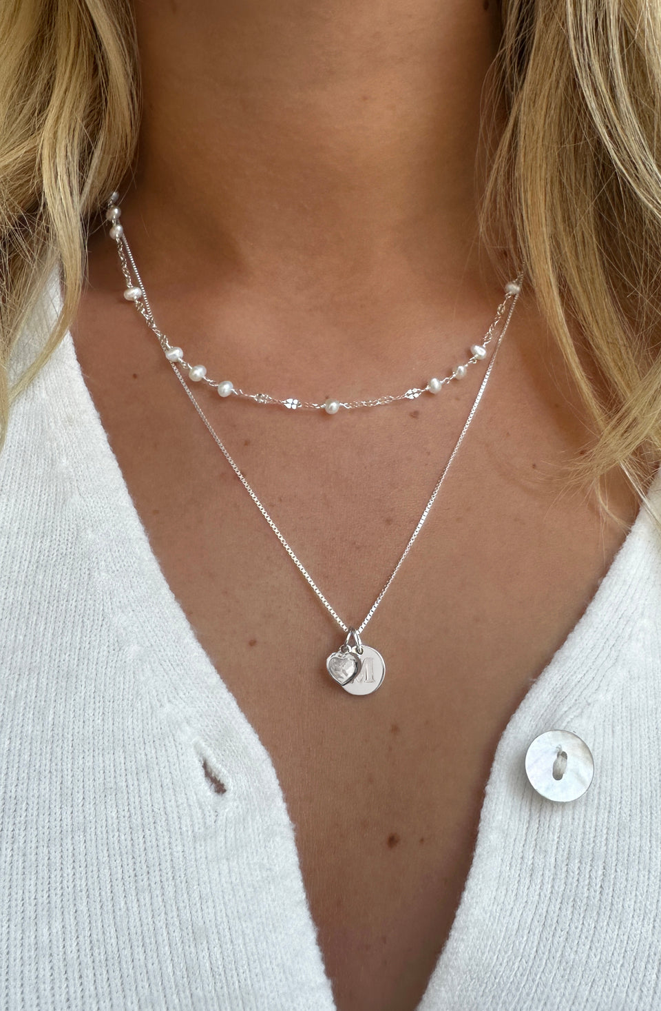 Short pearl necklace with a long charm necklace in sterling silver. 