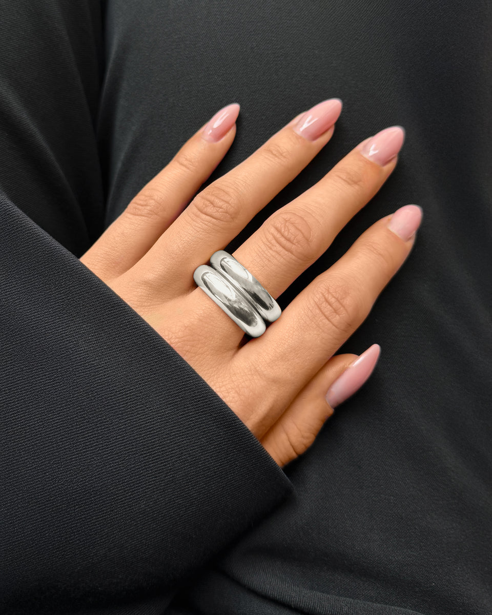 A close-up shot of a model wearing the Bolded Ring in silver, highlighting its substantial and rounded double-band design.