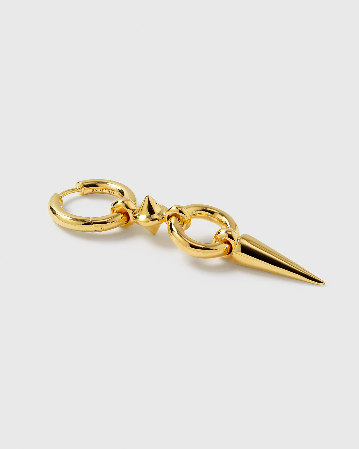 A product shot of the gold Juno Long Single Earring, laid out to display its design featuring a chunky hoop, a small spike, an interlocking link, and a long dangling spike.