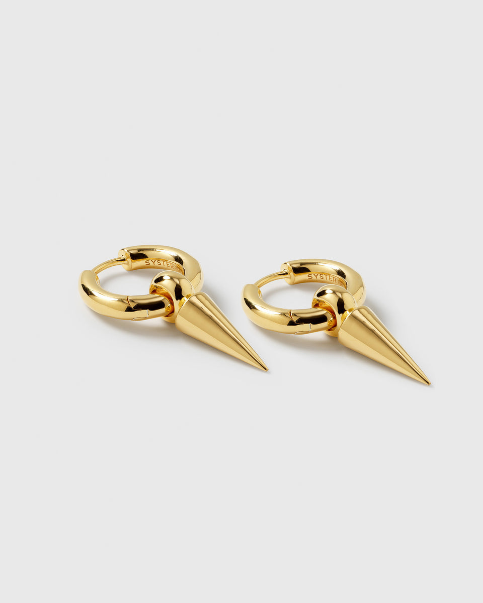 A product shot of the Juno Hoops in gold, featuring a pair of small hoops each with a large, dangling cone-shaped spike.