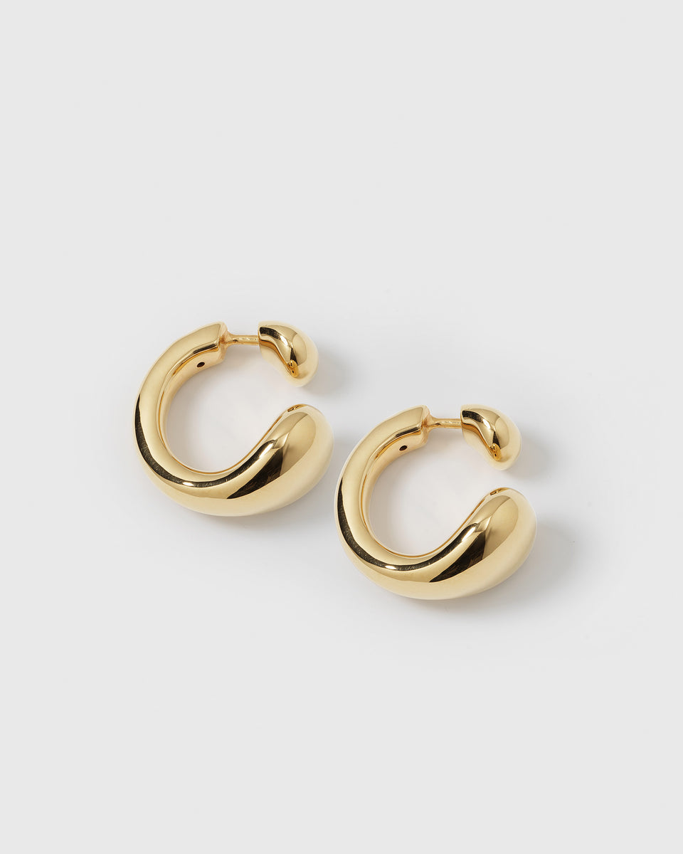 A product shot of the Bolded Drops Earrings in gold, showcasing their unique, bold, and curved drop-like design.