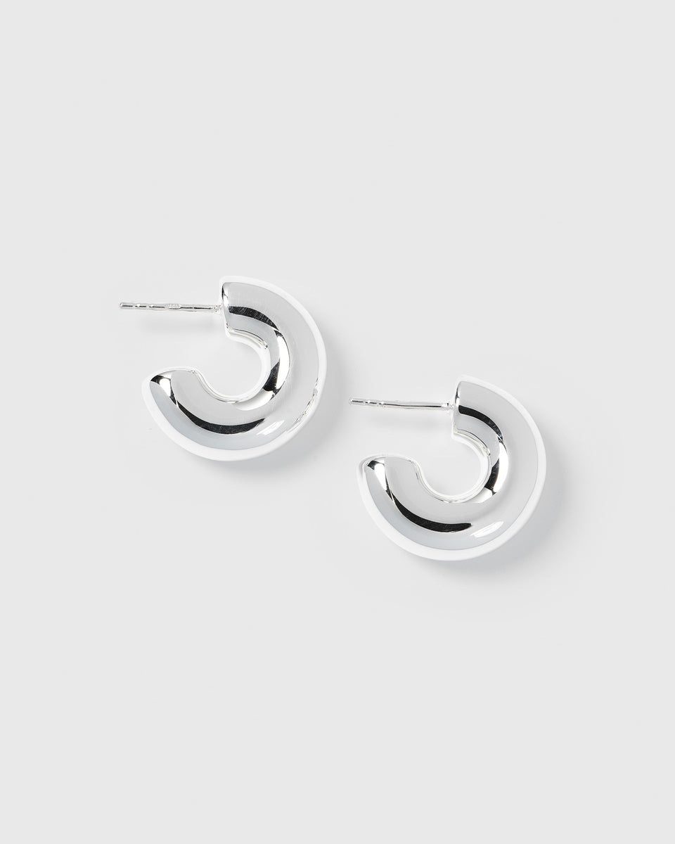 A product shot of the Bolded Little Sis Hoops in silver, showing the pair of chunky, C-shaped earrings.