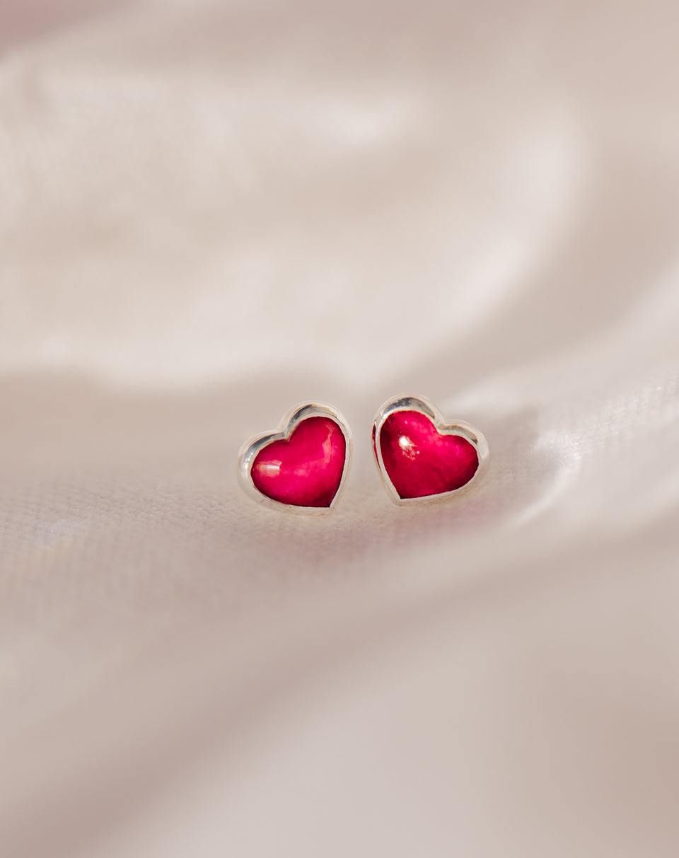 A close-up shot of the La La Love stud earrings, highlighting the heart-shaped pink quartz stones within their sterling silver settings.