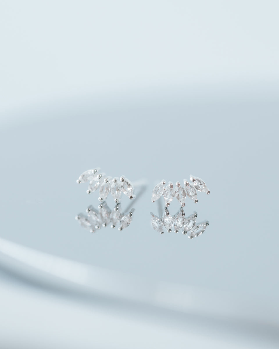 A product shot of the Theodora Earrings in silver, displaying their fan-shaped design made of sparkling, marquise-cut cubic zirconia stones.