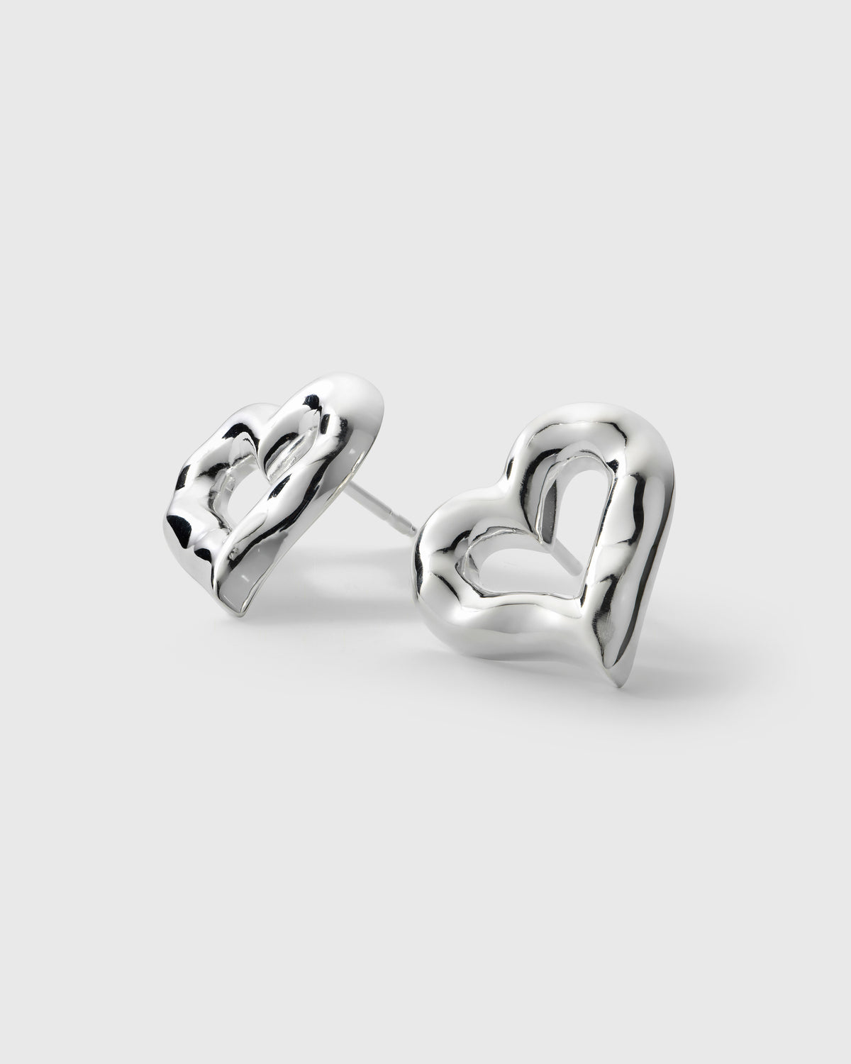 A product shot of the Puff Heart Earrings in silver, showcasing their chunky and organic heart-shaped design.