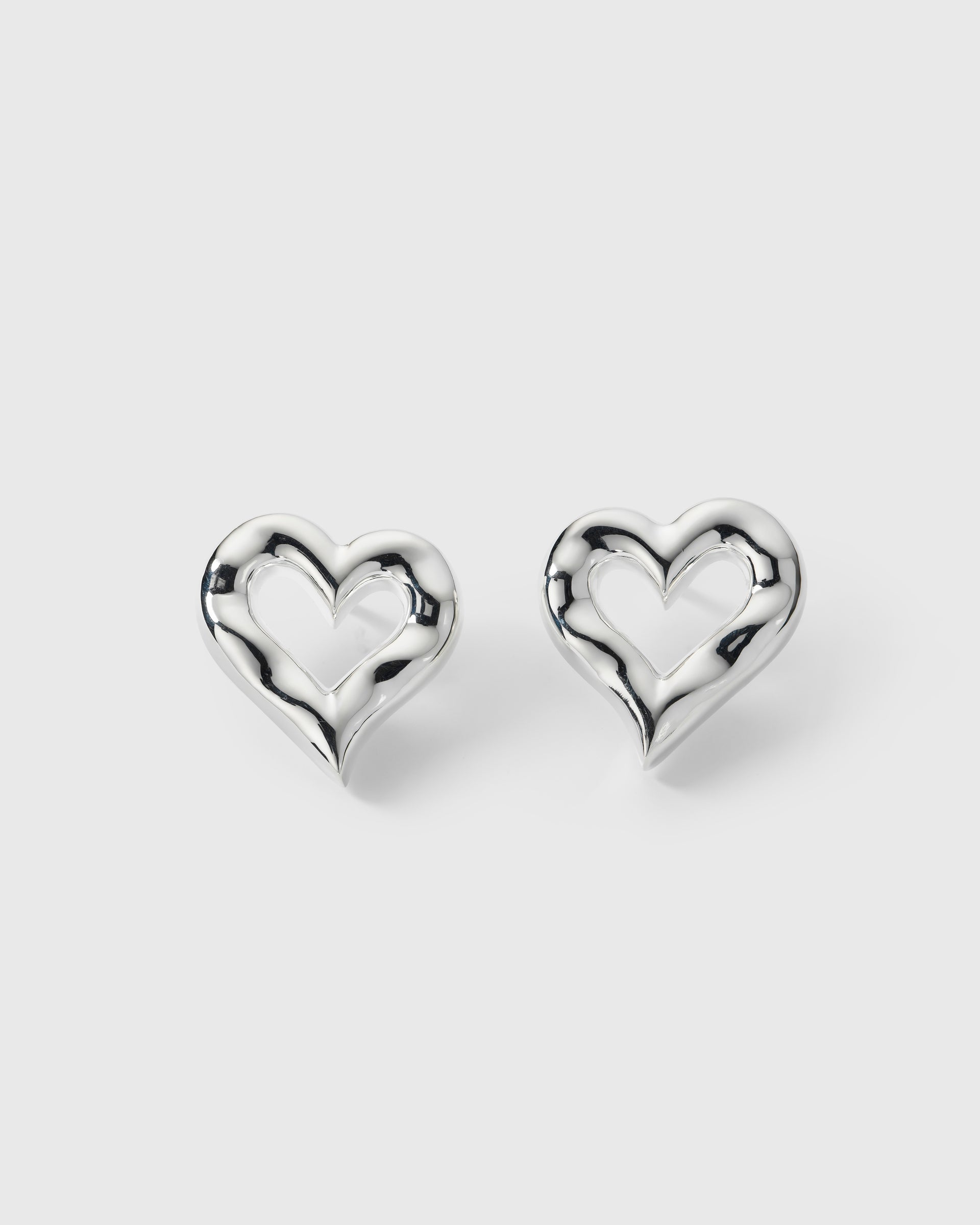 A product shot of the Puff Heart Earrings in silver, highlighting their chunky and organic heart-shaped design.