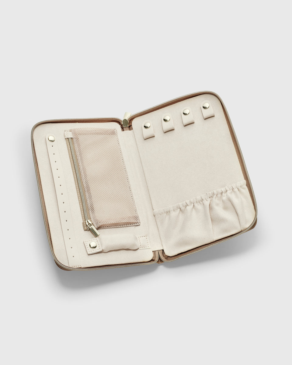 A product shot of the beige Jewelry Travel Case, opened to display its organized interior with various compartments for rings, earrings, and necklaces.