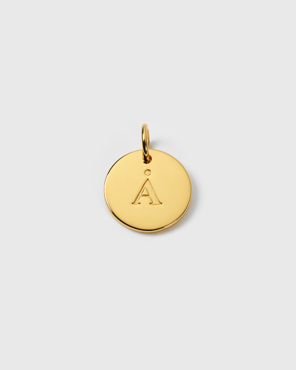 A product shot of the Beloved Big Letter Gold pendant, showing the circular charm engraved with the letter 'Å'.