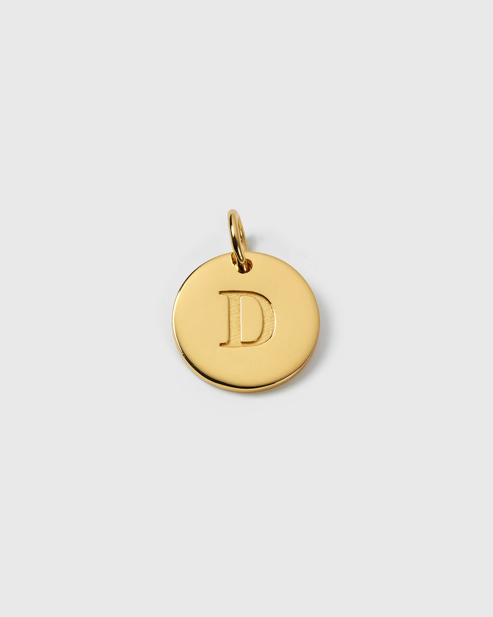 A product shot of the Beloved Big Letter charm in gold, featuring a round gold pendant with the letter 'D' engraved in the center.