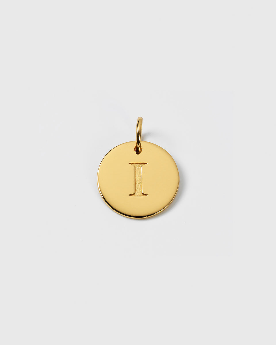 A product shot of the Beloved Big Letter charm in gold, featuring a round pendant with the letter 'I' engraved on its surface.
