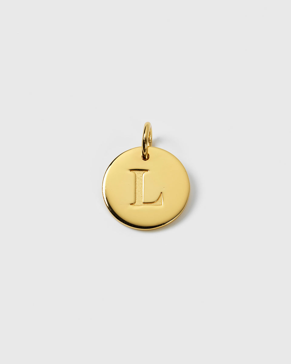 A product shot of the Beloved Big Letter Gold pendant, showing a circular gold charm with the letter 'L' engraved on it.