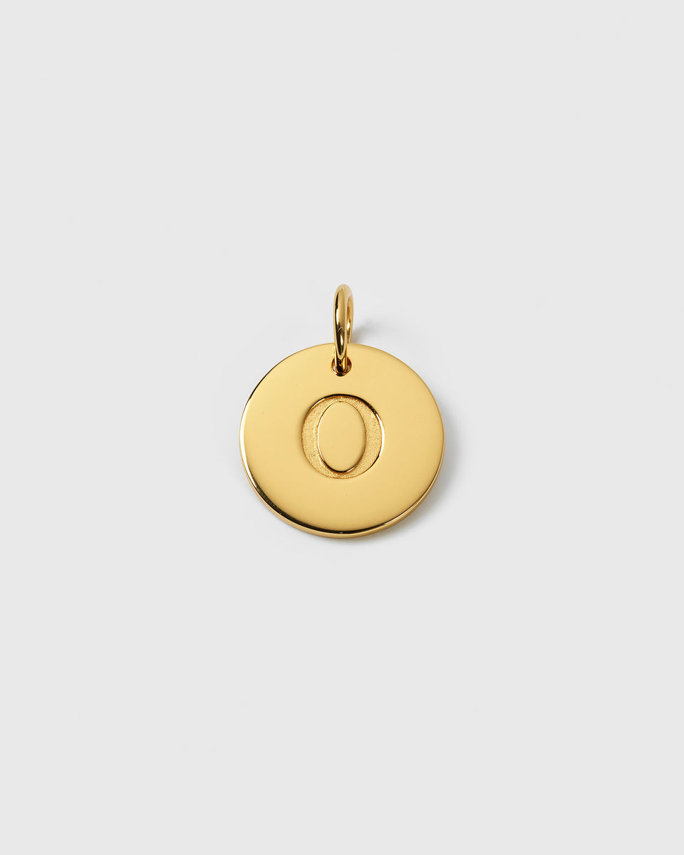 A product shot of the Beloved Big Letter Gold pendant, featuring the letter 'O' on a circular, polished gold charm.